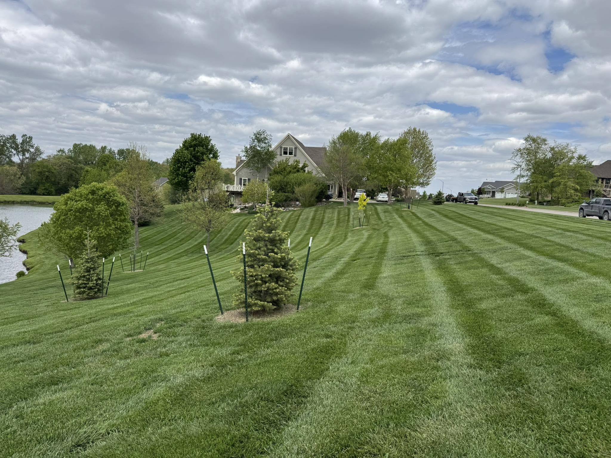 Striped lawn beside a lake